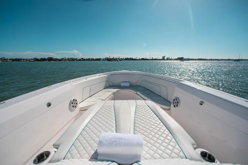 Slide: The Image of 2021 Intrepid 407 Nomad FE boat bow with luxurious seating on a sunny day. - 15