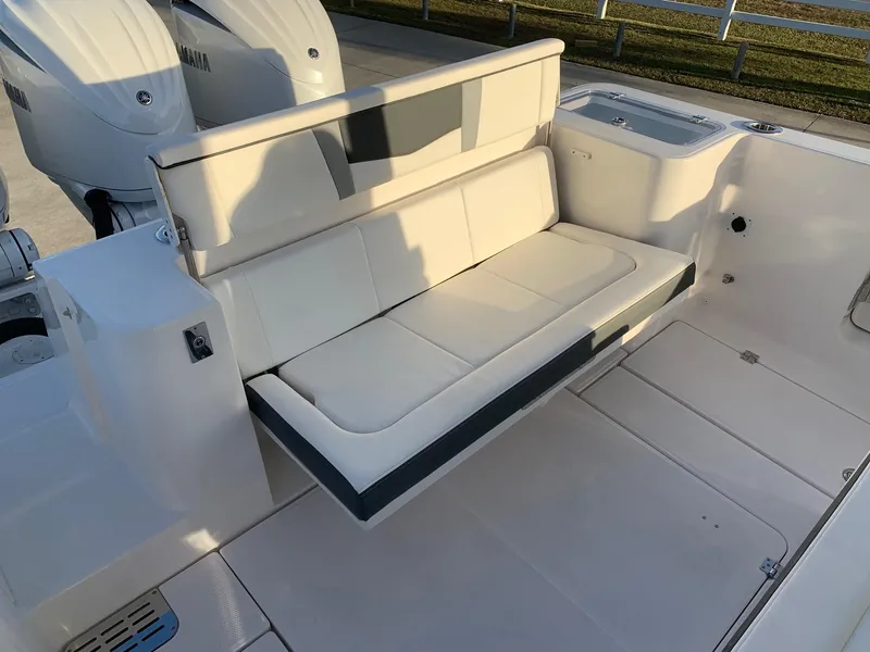 Slide: The Image of 2024 Robalo R360 boat with fold-down seating and twin Yamaha engines. - 10