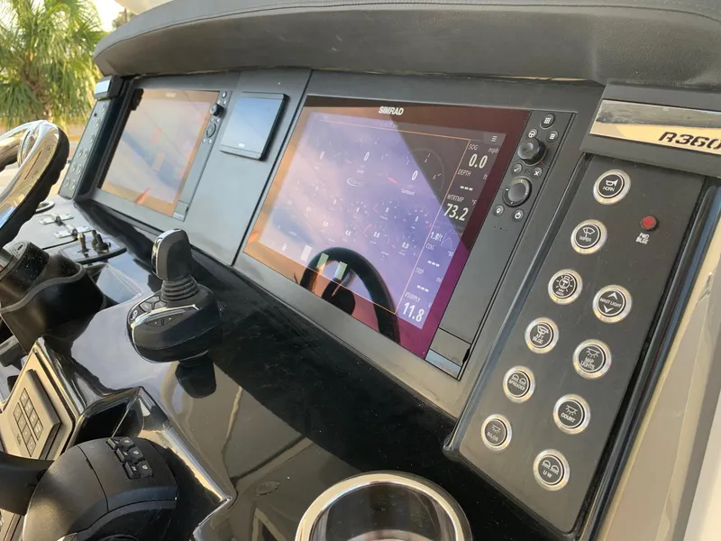 Slide: The Image of 2024 Robalo R360 boat dashboard with advanced navigation system and controls. - 13