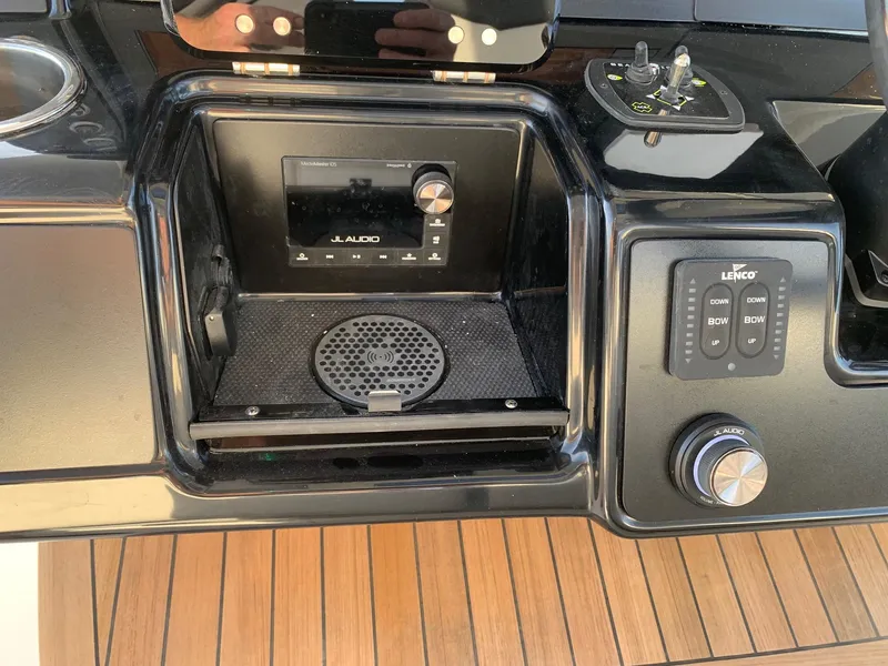 Slide: The Image of 2024 Robalo R360 boat dashboard with JL Audio system and Lenco controls. - 15