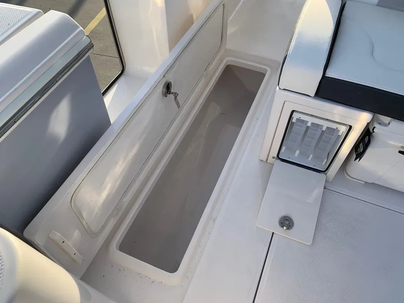 Slide: The Image of Open storage compartment on the 2024 Robalo R360 boat. - 18