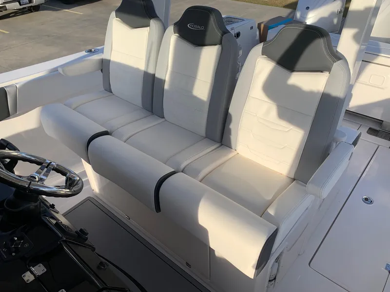 Slide: The Image of 2024 Robalo R360 boat seating area with three cushioned seats. - 20