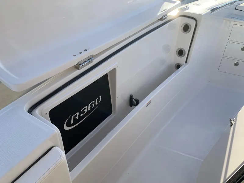 Slide: The Image of 2024 Robalo R360 boat storage compartment with open lid. - 23