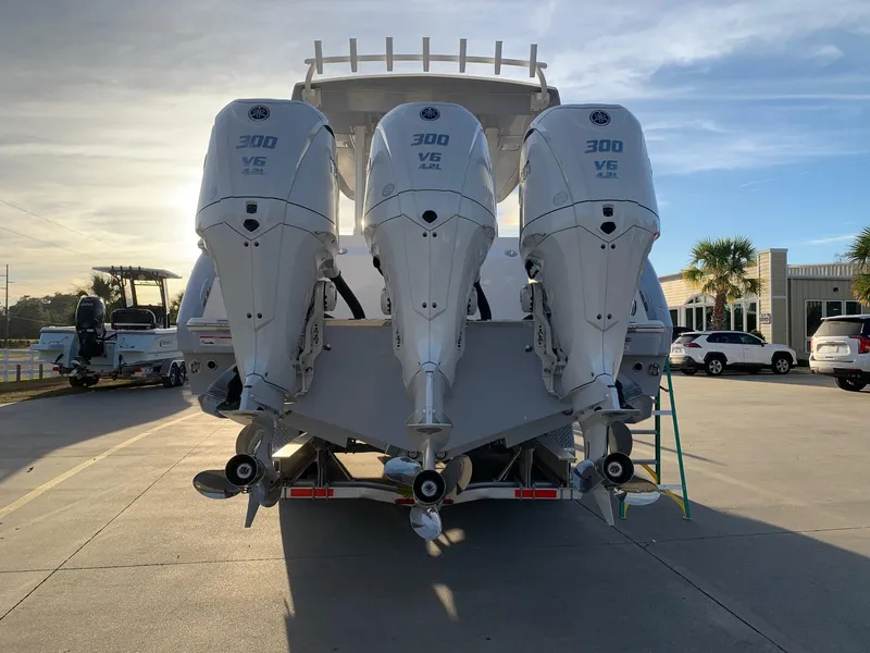 Slide: The Image of 2024 Robalo R360 boat with triple 300 V6 engines, rear view. - 4