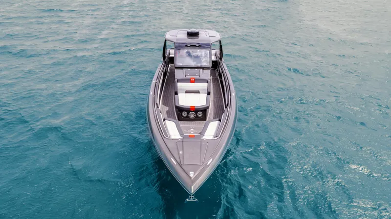 Slide: The Image of 2025 Cigarette 41 Nighthawk boat cruising on clear blue water. - 10