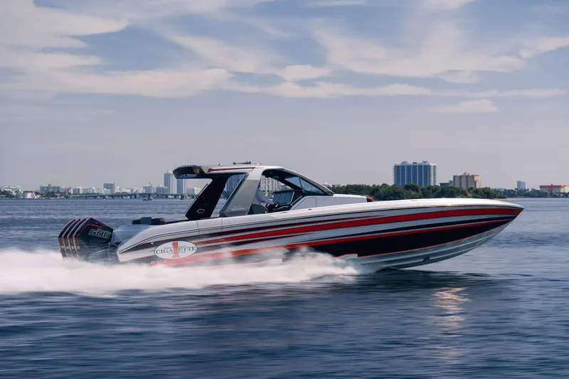 Slide: The Image of 2025 Cigarette 41 Nighthawk speedboat cruising on water with city skyline in background. - 11