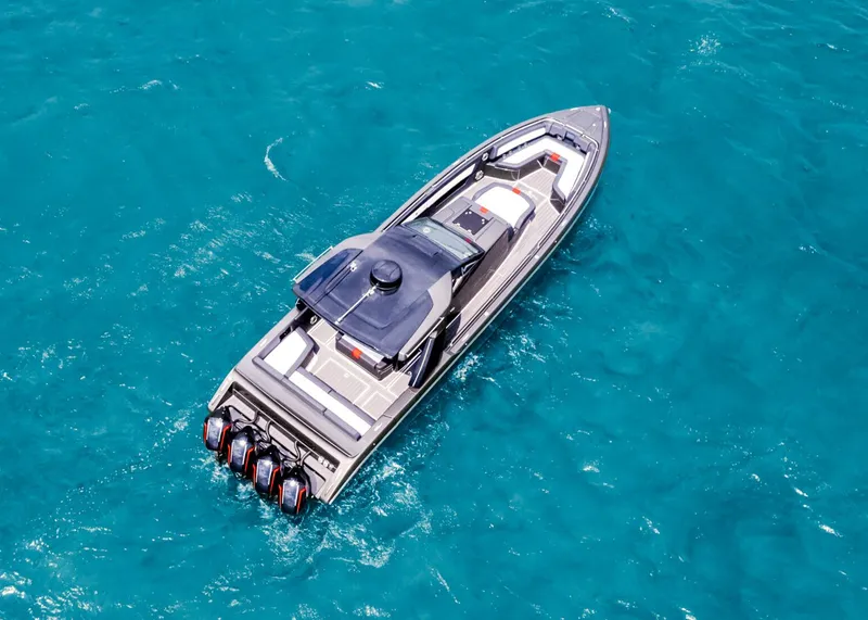 Slide: The Image of 2025 Cigarette 41 Nighthawk boat cruising on clear blue water. - 15