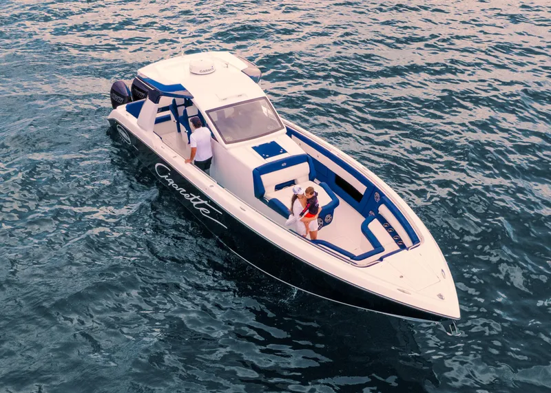 Slide: The Image of 2025 Cigarette 41 Nighthawk boat cruising on water with passengers. - 6