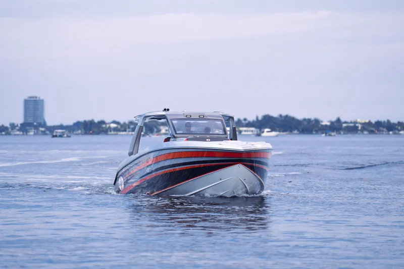 Slide: The Image of 2025 Cigarette 41 Nighthawk boat cruising on a calm water body. - 8