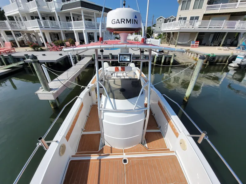 Slide: The Image of 1997 Glacier Bay 260 Canyon Runner boat docked, featuring Garmin navigation system. - 11