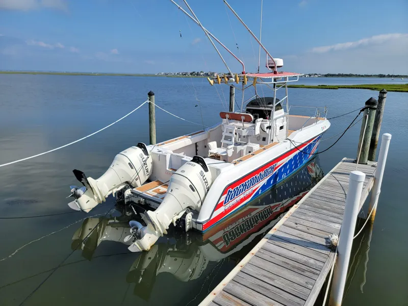 Slide: The Image of 1997 Glacier Bay 260 Canyon Runner boat docked with twin outboard motors. - 7