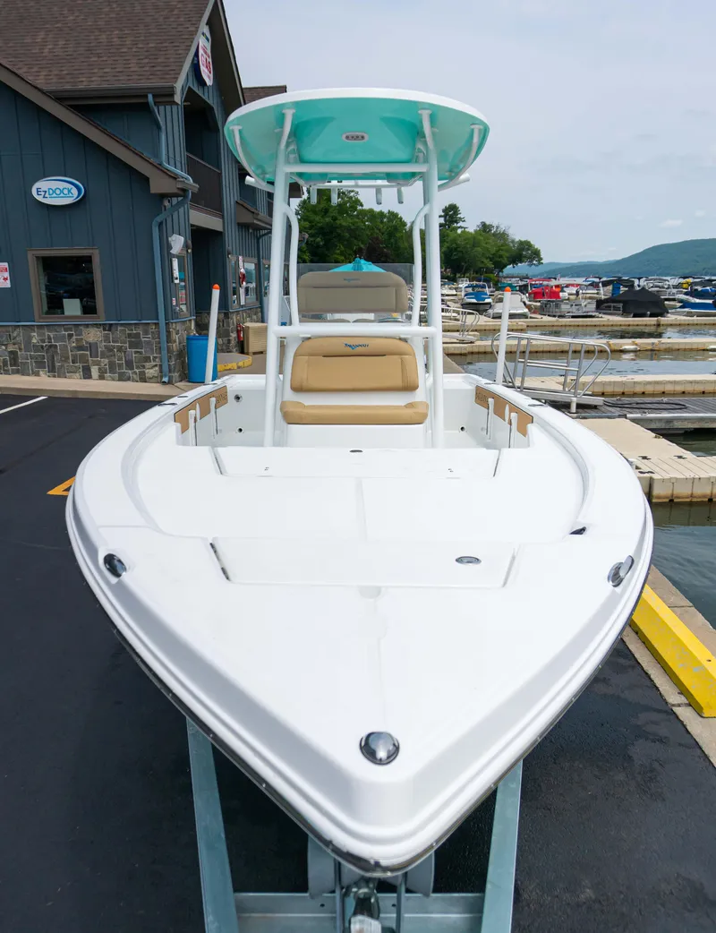 Slide: The Image of 2023 Savannah 220 IS boat docked at a marina, front view. - 14