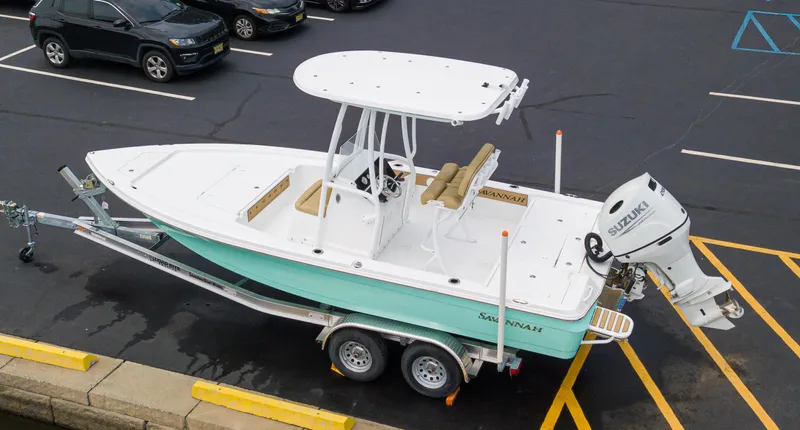 Slide: The Image of 2023 Savannah 220 IS boat on trailer in parking lot. - 2