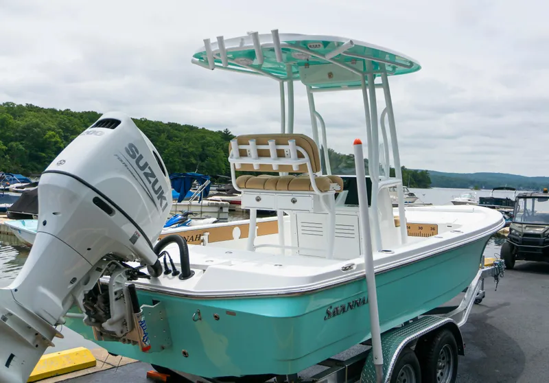 Slide: The Image of 2023 Savannah 220 IS boat with Suzuki outboard motor at marina. - 3