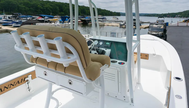 Slide: The Image of 2023 Savannah 220 IS boat at marina, featuring helm station and comfortable seating. - 4