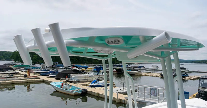 Slide: The Image of 2023 Savannah 220 IS boat docked at a marina with other boats. - 5