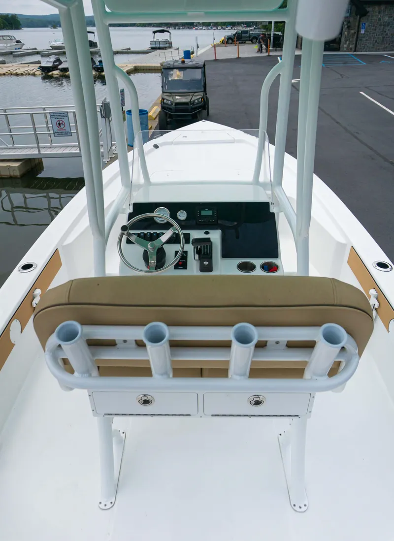 Slide: The Image of 2023 Savannah 220 IS boat interior with helm and seating. - 6