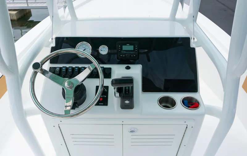 Slide: The Image of 2023 Savannah 220 IS boat console with steering wheel, gauges, and controls. - 8