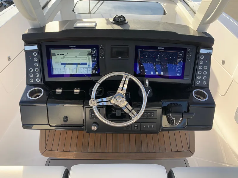 Slide: The Image of 2024 Robalo R360 boat dashboard with dual navigation screens and modern controls. - 10
