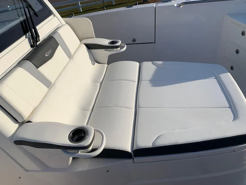 Slide: The Image of 2024 Robalo R360 boat with white cushioned seating and cup holders. - 24
