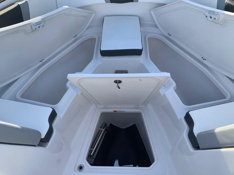 Slide: The Image of 2024 Robalo R360 boat interior storage compartments and seating. - 26