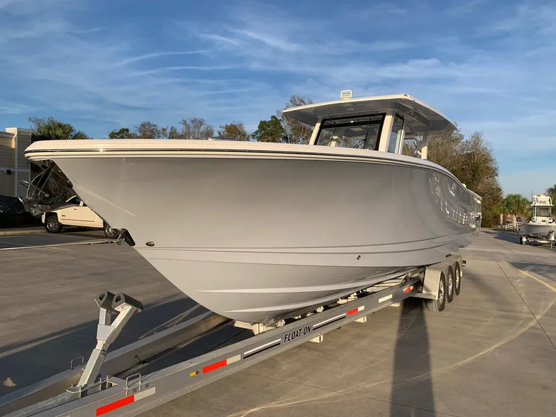 Slide: The Image of 2024 Robalo R360 boat on a trailer in a parking lot. - 3