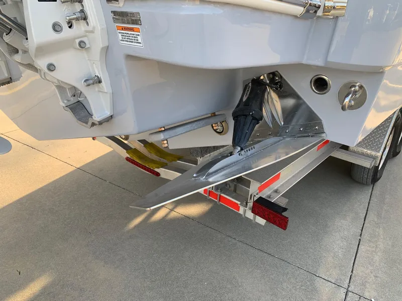 Slide: The Image of 2024 Robalo R360 boat stern on trailer, showing outboard motor and propeller. - 30