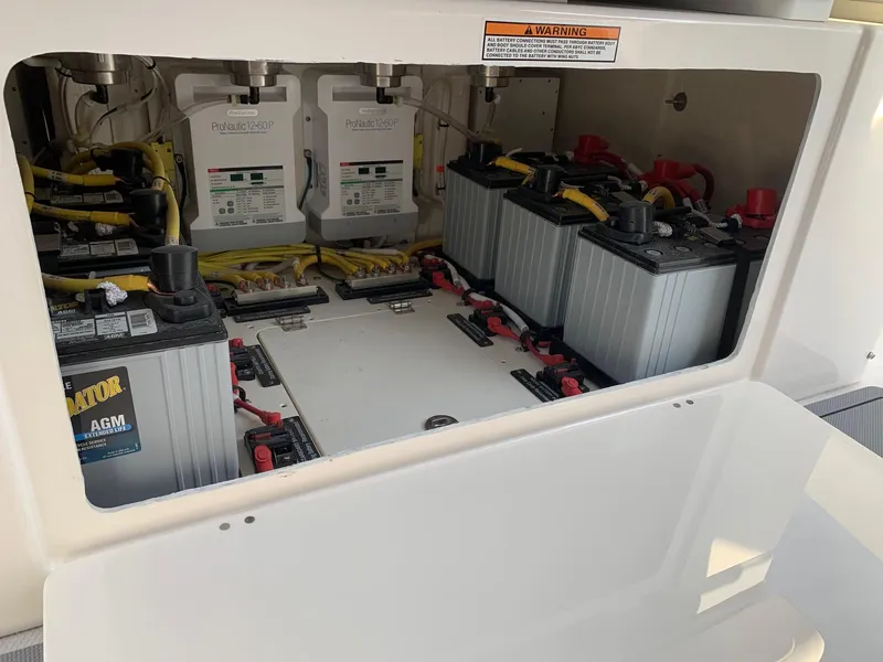 Slide: The Image of Battery compartment of 2024 Robalo R360 boat with AGM batteries and wiring. - 31