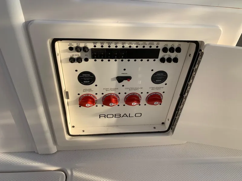 Slide: The Image of Control panel of 2024 Robalo R360 boat with switches and dials. - 32