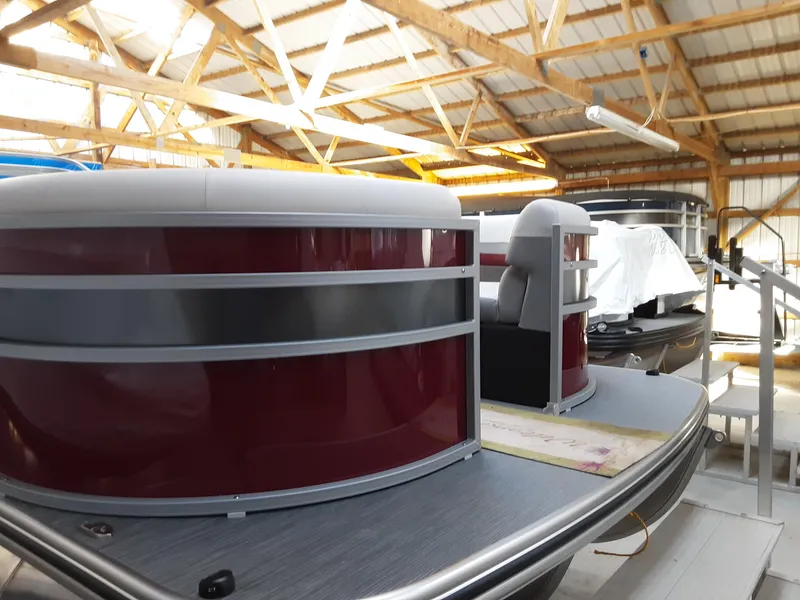 The Image of 2023 Lowe SS 230 pontoon boat in a storage facility. - 0