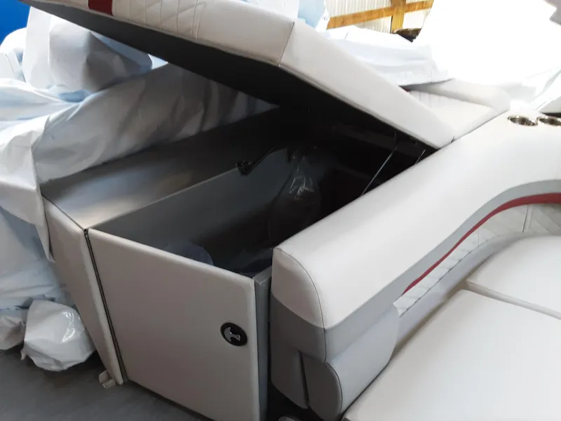 Slide: The Image of 2023 Lowe SS 230 boat with open storage compartment and white cushioned seating. - 11