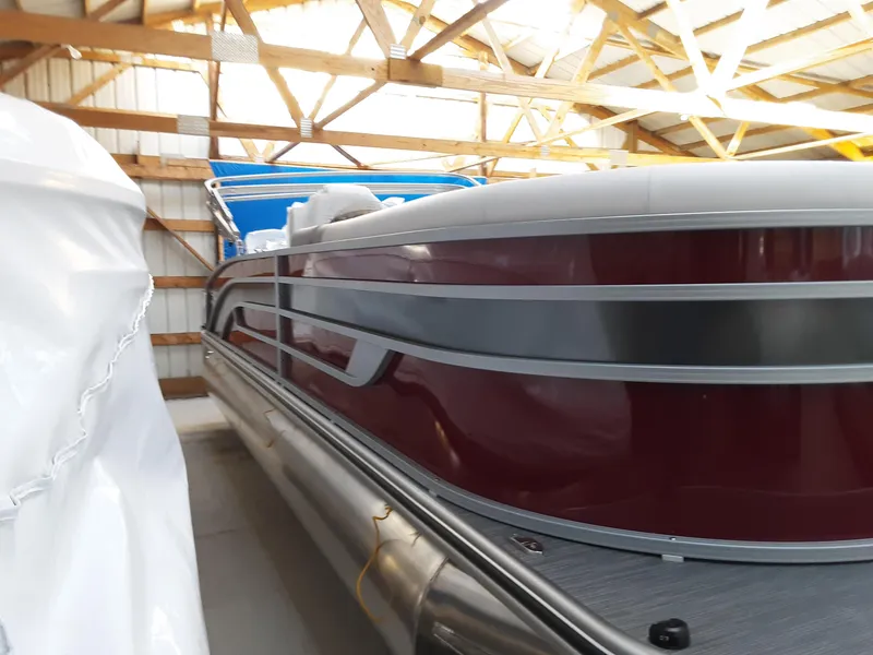 Slide: The Image of 2023 Lowe SS 230 pontoon boat in storage. - 2