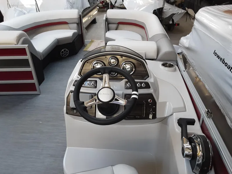 Slide: The Image of 2023 Lowe SS 230 boat interior with steering wheel and seating area. - 6