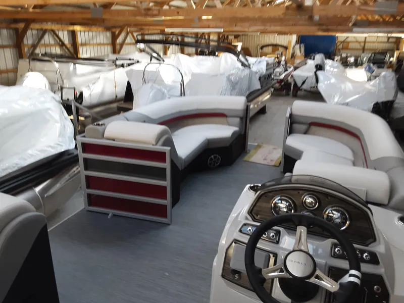 Slide: The Image of 2023 Lowe SS 230 pontoon boat interior in a storage facility. - 7