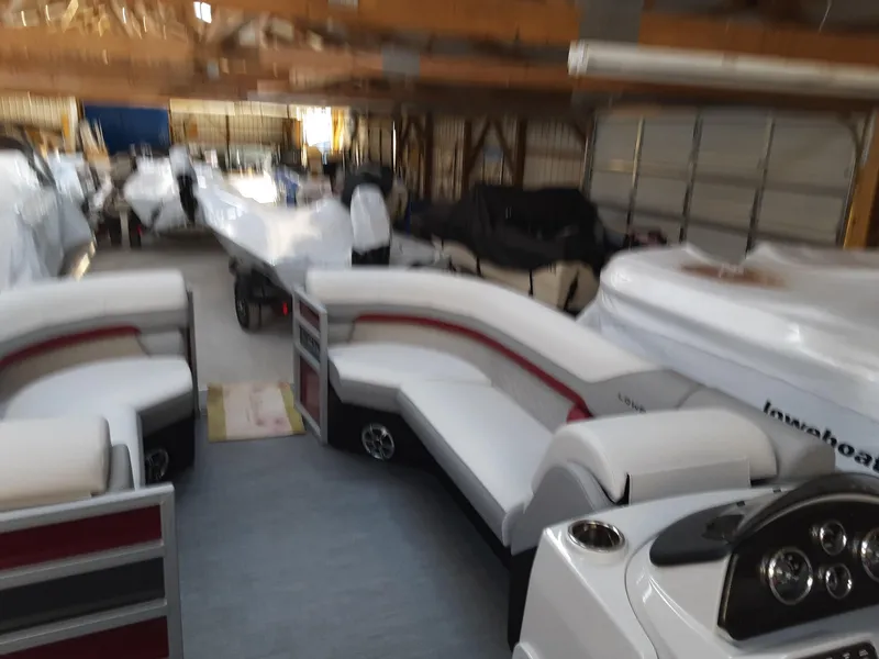 Slide: The Image of 2023 Lowe SS 230 pontoon boat in storage facility. - 8