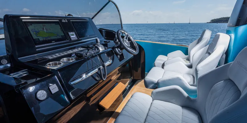 Slide: The Image of Interior cockpit of 2025 Solaris Power 44 Open yacht with luxurious seating and advanced navigation system. - 11