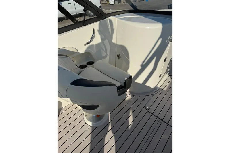 Slide: The Image of 2022 Stingray 235 LR boat interior with seating and cup holders. - 13