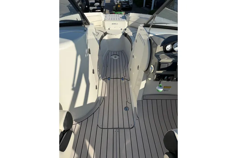 Slide: The Image of 2022 Stingray 235 LR boat interior with sleek, modern design and spacious layout. - 14