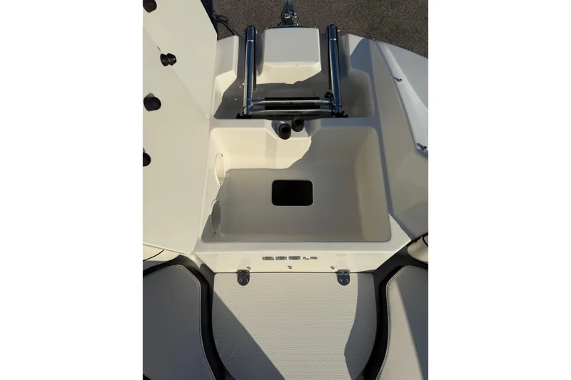 Slide: The Image of 2022 Stingray 235 LR boat interior storage compartment with ladder. - 18