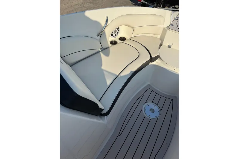 Slide: The Image of 2022 Stingray 235 LR boat interior with cushioned seating and sleek flooring. - 20