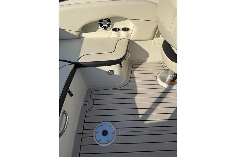 Slide: The Image of 2022 Stingray 235 LR boat interior with beige seating and striped flooring. - 24