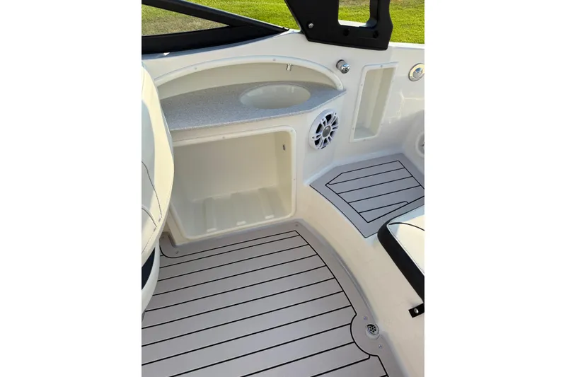 Slide: The Image of 2022 Stingray 235 LR boat interior with storage and speaker. - 25