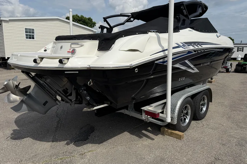 Slide: The Image of 2022 Stingray 235 LR boat on trailer, rear view, black and white design. - 5