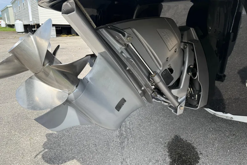 Slide: The Image of 2022 Stingray 235 LR boat propeller and outdrive close-up on pavement. - 6
