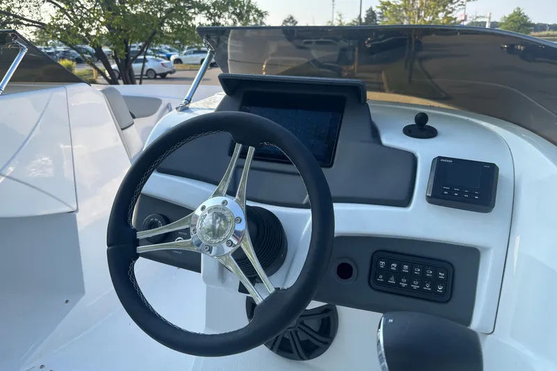 Slide: The Image of Steering console of 2023 Tahoe 210 Si Limited boat with modern controls. - 4