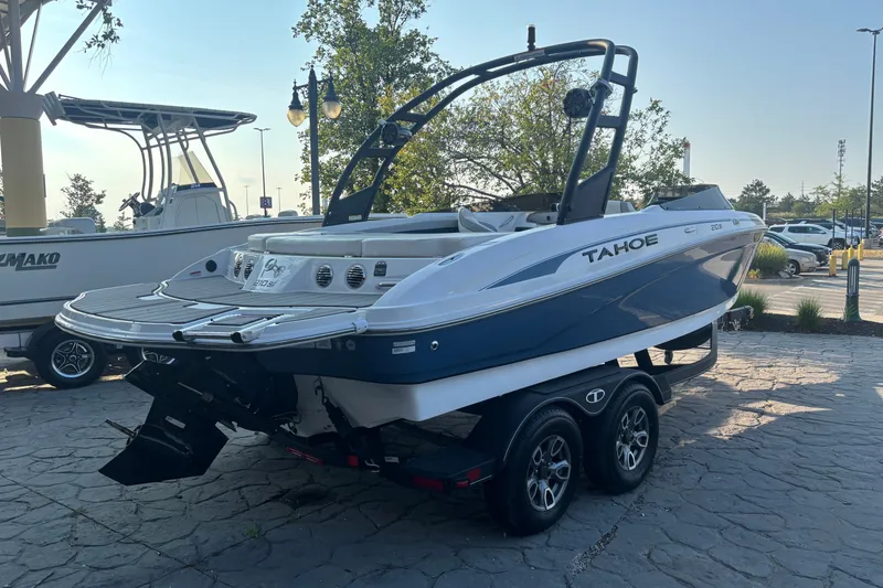 Slide: The Image of 2023 Tahoe 210 Si Limited boat on trailer, parked outdoors. - 5