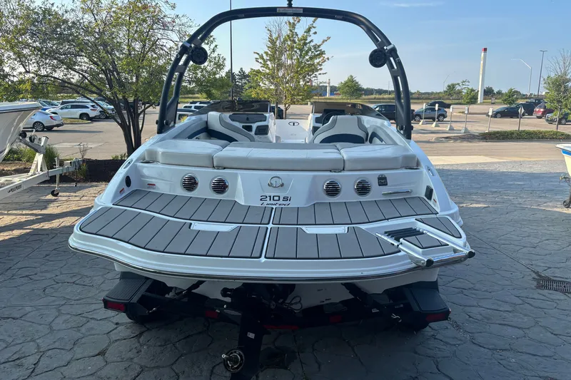 Slide: The Image of 2023 Tahoe 210 Si Limited boat, rear view, parked on a stone pavement. - 6