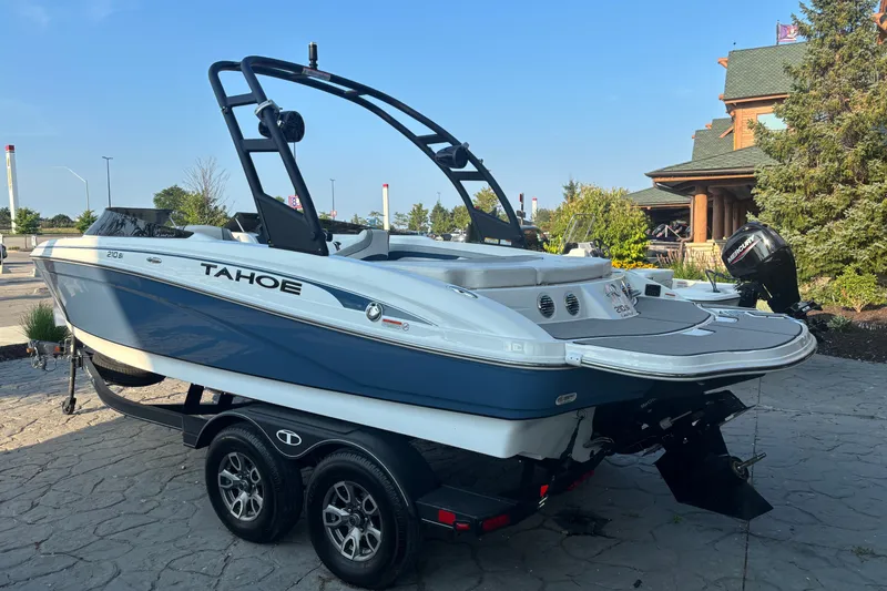 Slide: The Image of 2023 Tahoe 210 Si Limited boat on trailer, parked outdoors. - 3