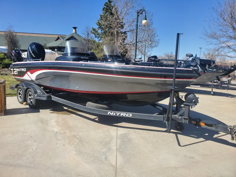 Slide: The Image of 2020 Nitro ZV21 fishing boat on trailer in outdoor setting. - 0