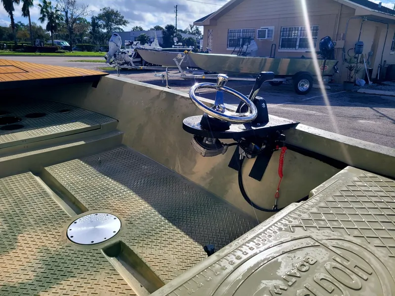 Slide: The Image of 2021 Hog Island Boat Works SW16 interior with steering wheel and textured flooring. - 10